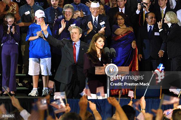 President George W. Bush waves to the crowd with Theresa Earnhardt , widow of NASCAR driver Dale Earnhardt, January 30, 2002 in Daytona Beach, FL....