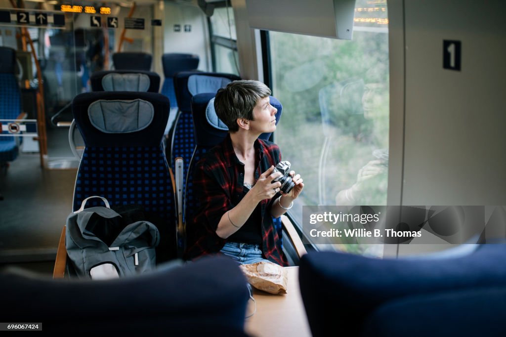 A Backpacker Enjoying The Scenery During A Train Journey