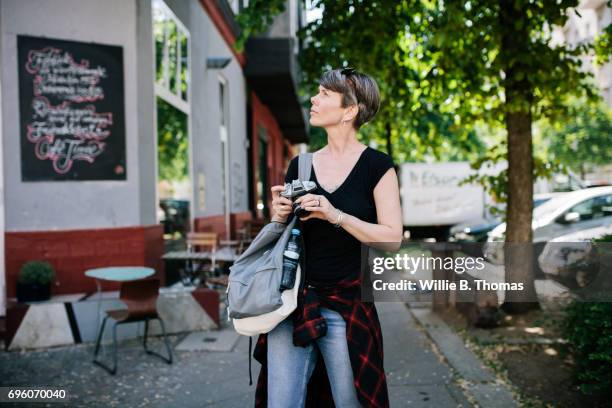 backpacker exploring the streets with her camera - 7894 stock pictures, royalty-free photos & images