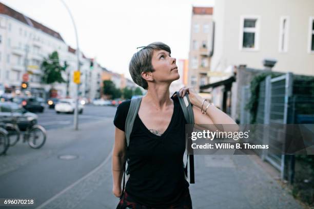 portrait mature backpacker walking down the street - 35 female outdoors stock pictures, royalty-free photos & images