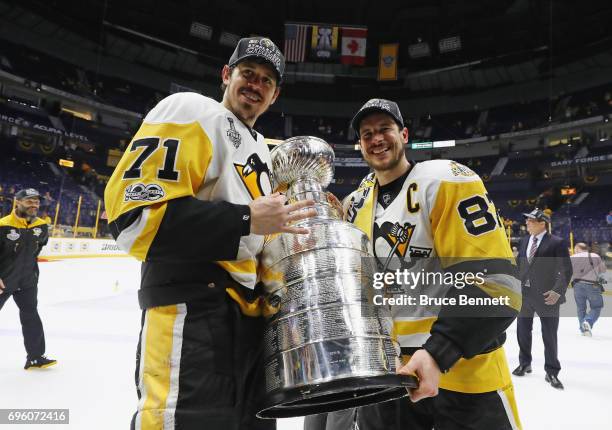 Evgeni Malkin and Sidney Crosby of the Pittsburgh Penguins celebrate with the Stanley Cup following a victory over the Nashville Predators in Game...