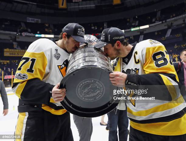 Evgeni Malkin and Sidney Crosby of the Pittsburgh Penguins celebrate with the Stanley Cup following a victory over the Nashville Predators in Game...