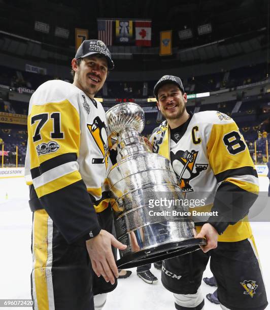Evgeni Malkin and Sidney Crosby of the Pittsburgh Penguins celebrate with the Stanley Cup following a victory over the Nashville Predators in Game...
