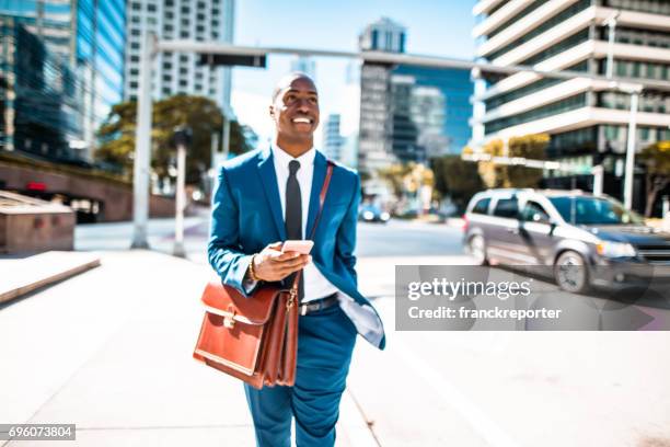 businessman on the phone in the miami downtown - walking business man outside stock pictures, royalty-free photos & images