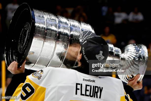 Marc-Andre Fleury of the Pittsburgh Penguins celebrates with the Stanley Cup Trophy after they defeated the Nashville Predators 2-0 to win the 2017...