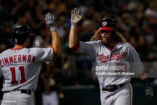Jayson Werth of the Washington Nationals is congratulated by Ryan Zimmerman after hitting a home run against the Oakland Athletics during the sixth...