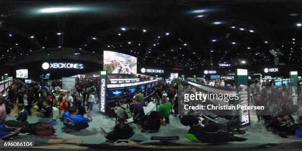 Game enthusiasts and industry personnel visit the Microsoft XBox exhibit during the Electronic Entertainment Expo E3 at the Los Angeles Convention...