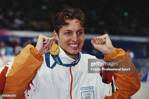 Dutch world record holding swimmer Pieter van den Hoogenband celebrates with his gold medal for the Netherlands team after finishing in first place...