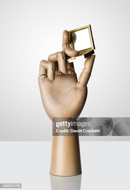wooden hand holding powder compact - wooden hand mirror stock pictures, royalty-free photos & images