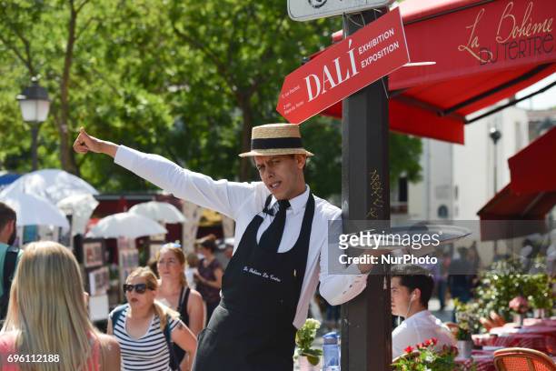 Garcon du Cafe' from 'La Boheme Du Tertre' trying to invite passers-by at The Place du Tertre square in Montmartre quarter. On Friday, June 14 in...