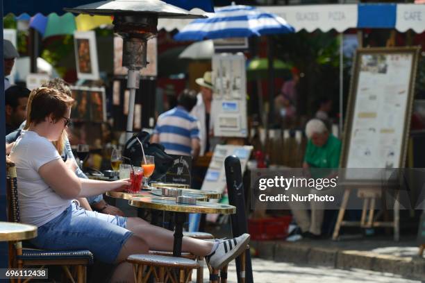 People enjoy a cafe and reste at The Place du Tertre square in Montmartre quarter. On Friday, June 14 in Paris, France.