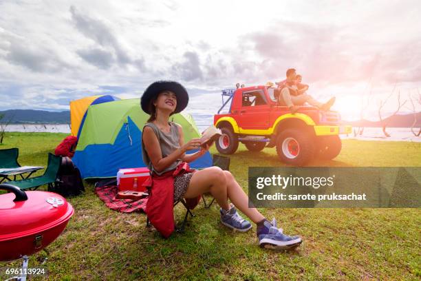 group of man and woman enjoy traveling with convertible off road car, sky cleared in background . holiday , vacation , summer concept . - campfire stories stock pictures, royalty-free photos & images