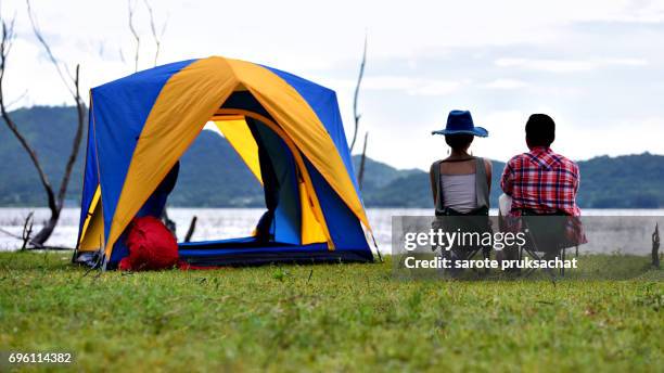 young couple enjoy camping outdoors , sky cleared in background . holiday , vacation , summer concept . - campfire stories stock pictures, royalty-free photos & images