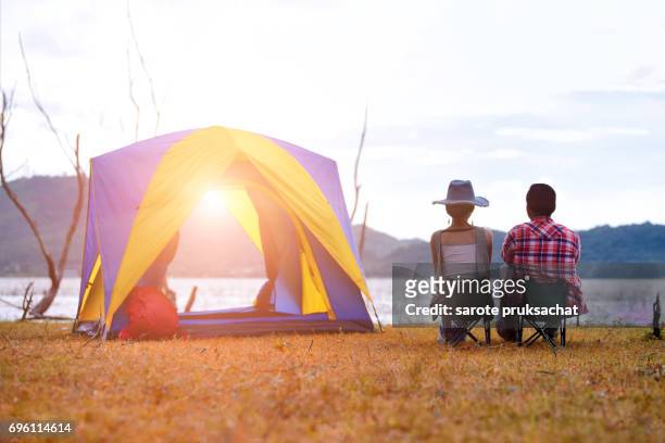 young couple enjoy camping outdoors , sky clear in background. holiday , vacation , summer concept - campfire stories stock pictures, royalty-free photos & images