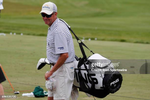 Golfer Davis Love III caddies for his son Davis Love IV during the practice round for the 117th US Open on June 14, 2017 at Erin Hills in Erin,...