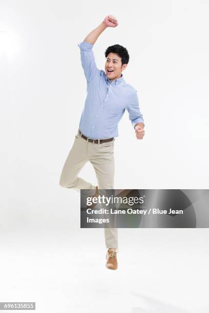 excited young man cheering - yes stockfoto's en -beelden