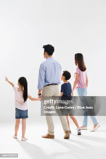 cheerful young family - couple walk white background stock pictures, royalty-free photos & images