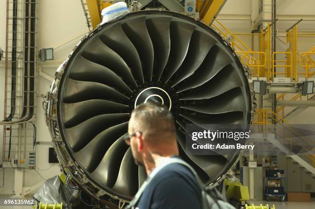 Rolls-Royce employee passes a Rolls-Royce Trent XWB airplane engine to be used in the Airbus A350 XWB aircraft, on June 14, 2017 in Berlin, Germany....