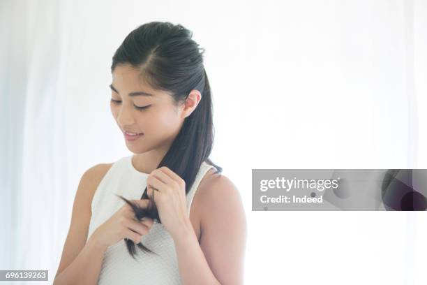 young woman touching her hair - 髪の毛 ストックフォトと画像