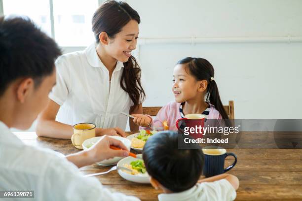 family having meals at table - family at dining table stock pictures, royalty-free photos & images