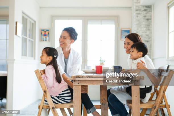 side view of family at table - child eat side stock-fotos und bilder