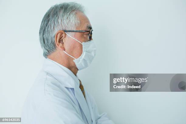 profile view of scientist, wearing protective mask - surgical mask profile stock pictures, royalty-free photos & images