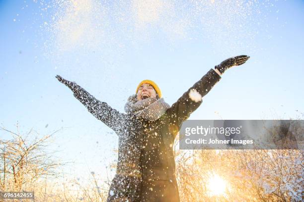 woman throwing snow - johner images bildbanksfoton och bilder