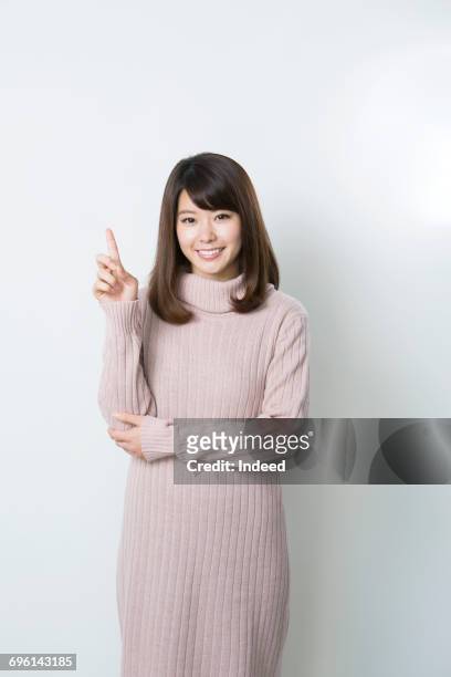 young woman pointing index finger - 人差し指 女性 ストックフォトと画像