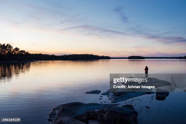 silhouette of person at water - non urban scene stock pictures, royalty-free photos & images