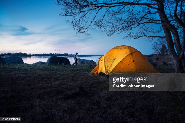 boy near tent - stockholm beach stock pictures, royalty-free photos & images