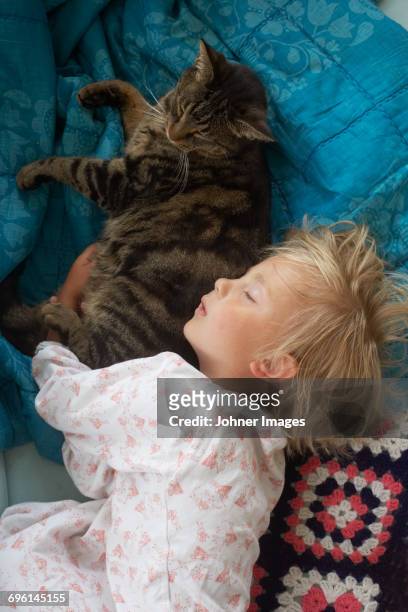Girl sleeping with cat