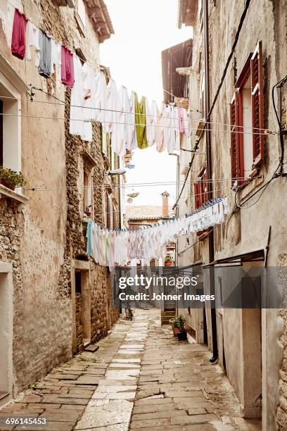 laundry hanging above narrow street - stockholm old town stock pictures, royalty-free photos & images