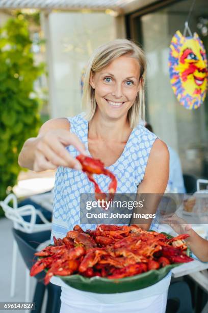 mature woman with bowl of crayfish - swedish culture fotografías e imágenes de stock