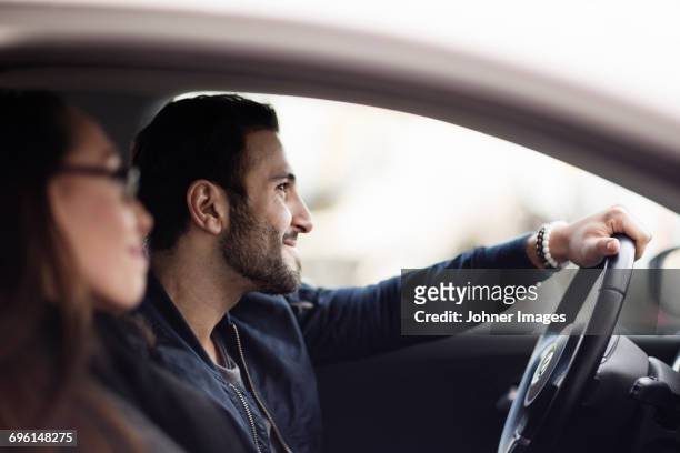couple in car - couple in car smiling stock pictures, royalty-free photos & images