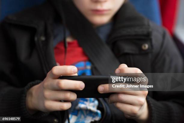 boy with cell phone, close-up - play bus stock pictures, royalty-free photos & images