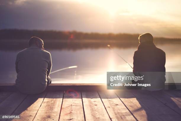 man fishing at lake - fishing ストックフォトと画像