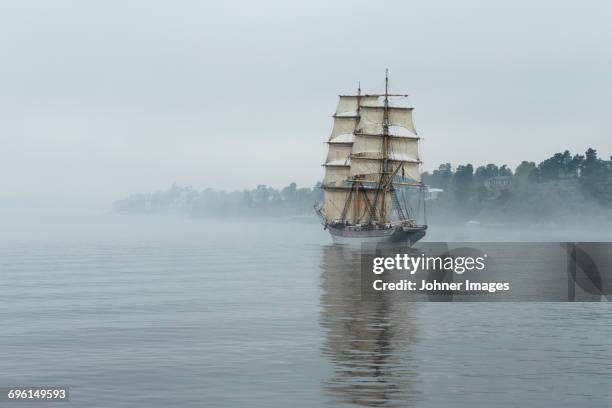 tall ship on foggy sea - boat old stock-fotos und bilder