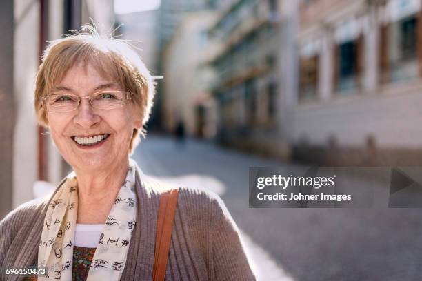 portrait of smiling senior woman - city 70's stock pictures, royalty-free photos & images