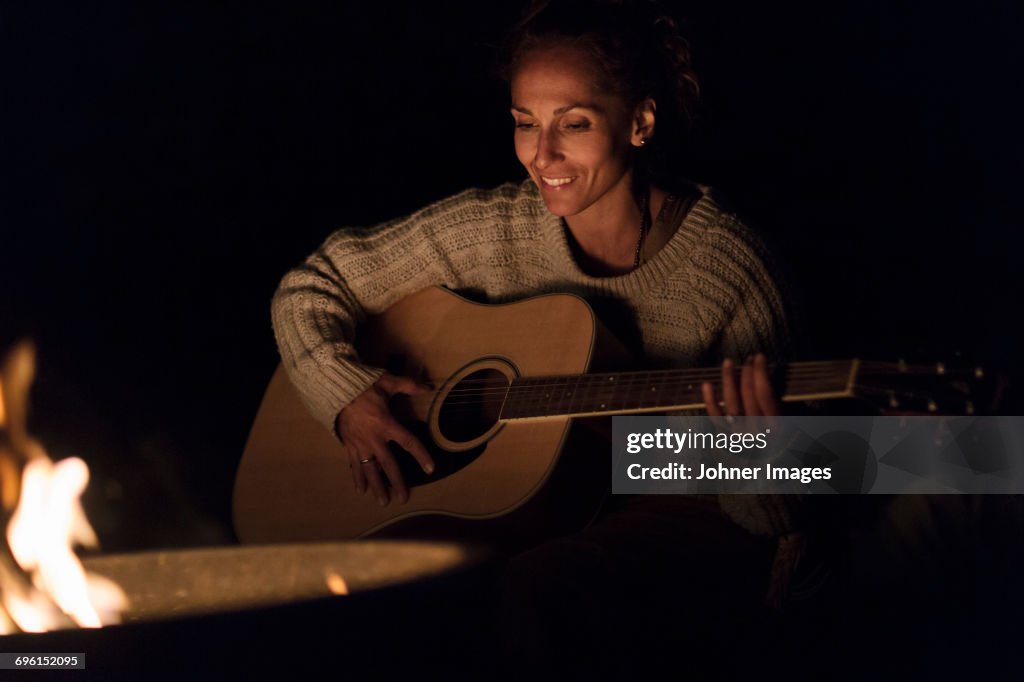 Woman playing guitar