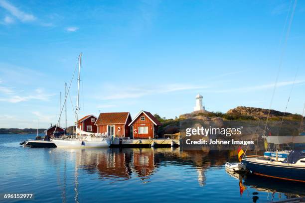 sailing boats moored at coast - sweden archipelago stock pictures, royalty-free photos & images