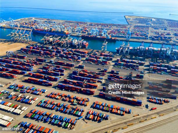 aerial view of the container port at san pedro in los angeles, with ships docked and containers awaiting loading. a commercial freight dockyard. - la waterfront stock pictures, royalty-free photos & images