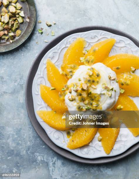 orange and whipped cream on plate - vispgrädde bildbanksfoton och bilder