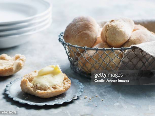 bun with butter on table - bread and butter stock pictures, royalty-free photos & images