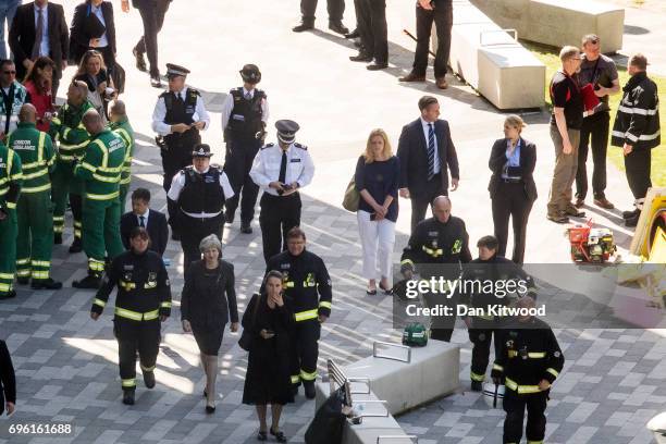 Prime Minister Theresa May speaks to Dany Cotton, Commissioner of the London Fire Brigade, with members of the fire service as she visits Grenfell...