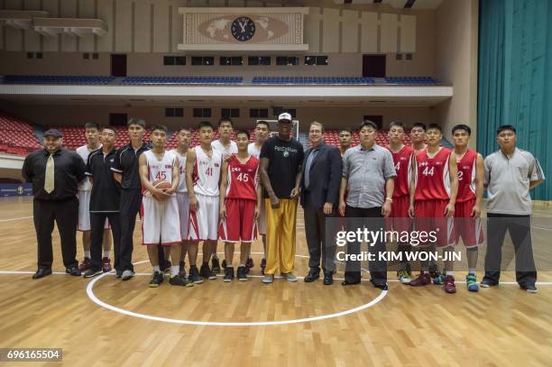 Former NBA star Dennis Rodman of the US poses with North Korean basketball players at the Pyongyang Indoor Stadium on June 15, 2017 Rodman arrived in...