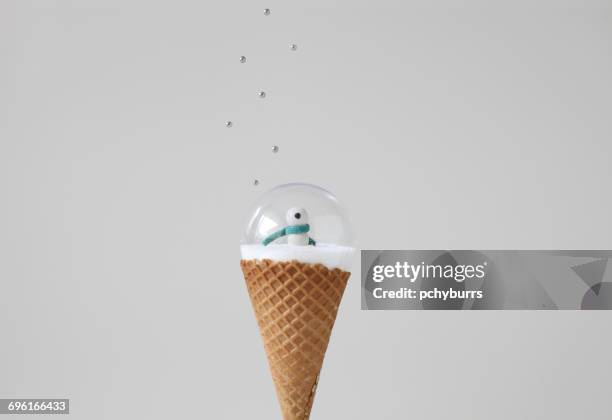 snow globe on ice cream cone with sprinkles - empty snow globe stockfoto's en -beelden