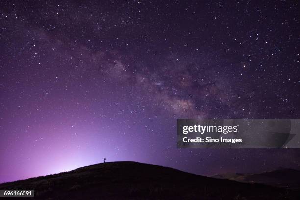 milky way galaxy on purple night sky - dali universe stock pictures, royalty-free photos & images