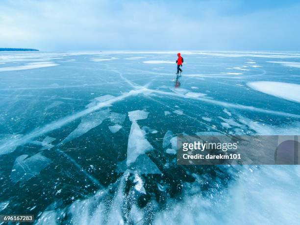 man walking across frozen lake, apostle islands, wisconsin, america, usa - paesaggio spettacolare foto e immagini stock
