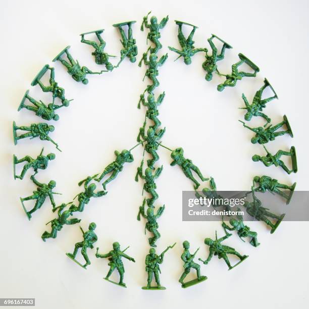 plastic toy solders in shape of peace sign - toy soldier stock pictures, royalty-free photos & images