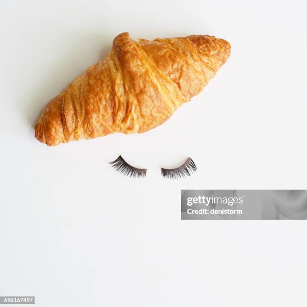 conceptual french face - croissant white background stock-fotos und bilder